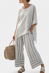 Talvora | Elegante blusa asimétrica y pantalones de rayas